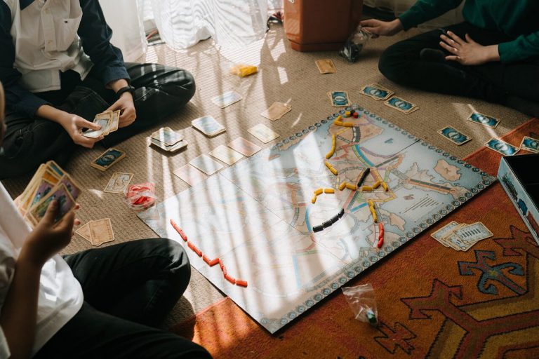 Four childhood friends playing a challenging strategy board game